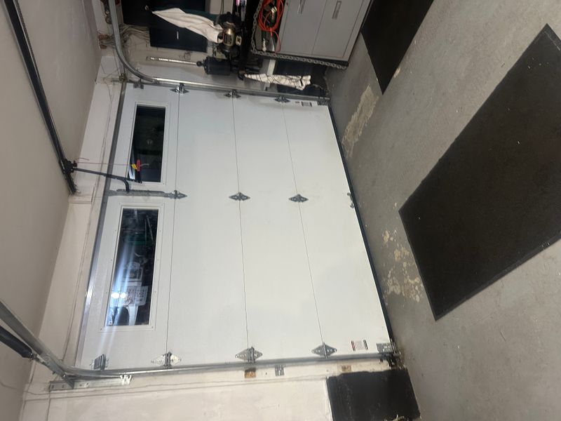 Commercial sectional door with chain hoist opener system interior view — MA